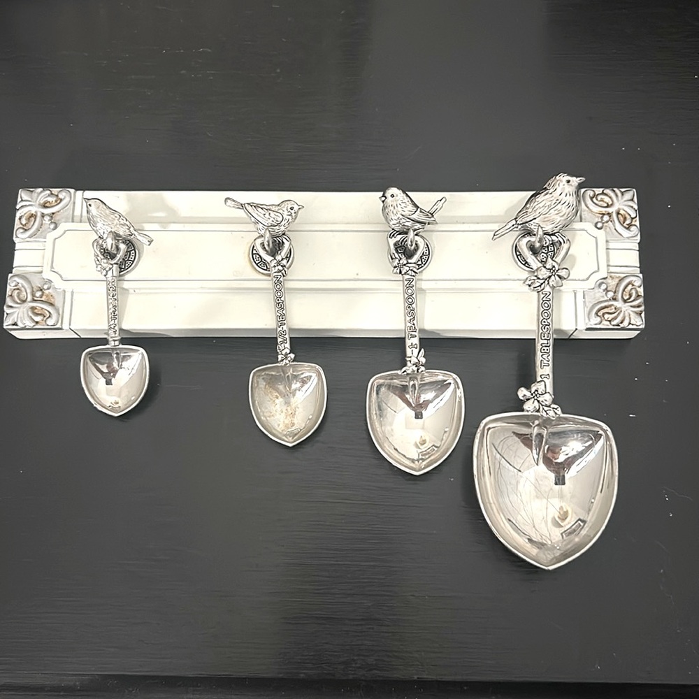 Decorative measuring spoons and hanging rack.
